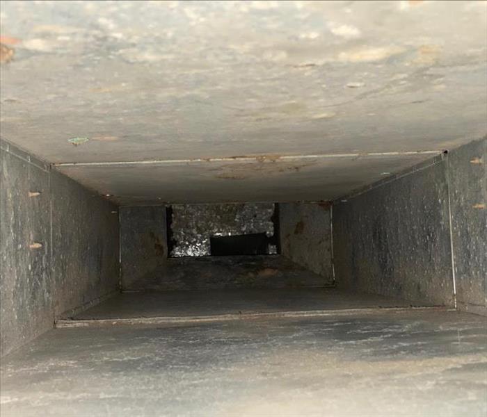 Interior view of metal air duct thoroughly cleaned and free of previous dirt and debris.