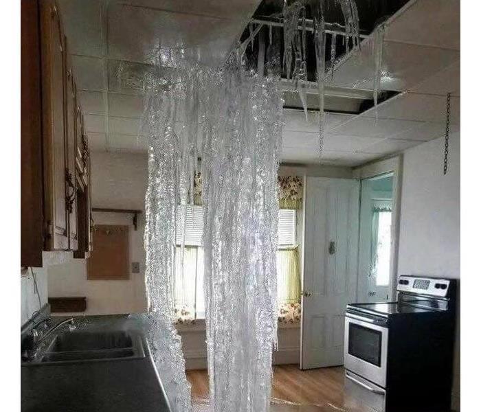 A kitchen with severe water damage to the ceiling